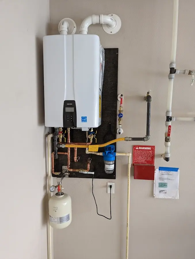 Professional plumber installing copper piping in a Cary home